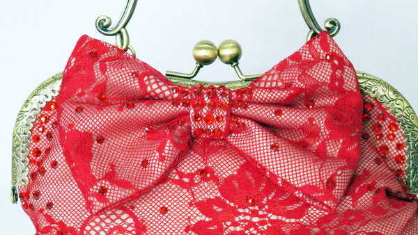 Red lace handbag with bow and antique brass handle, handmade by Rockstars and Royalty