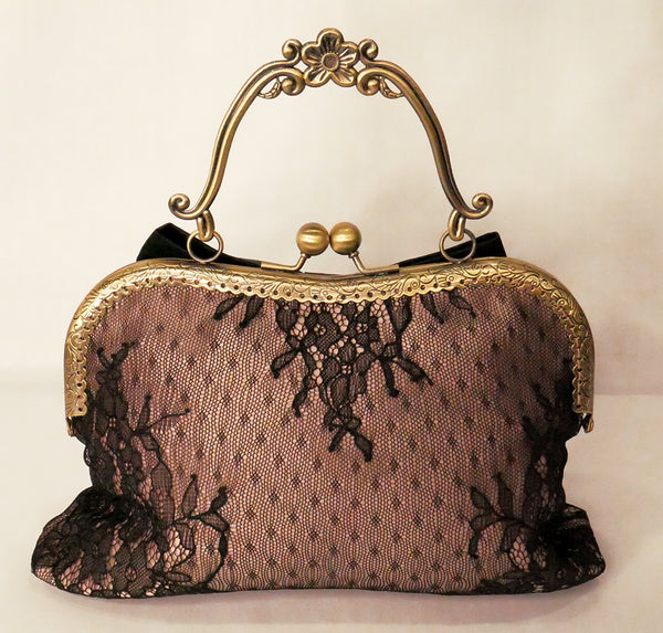 Black lace over blush satin handbag with black bow and antique brass frame with handle