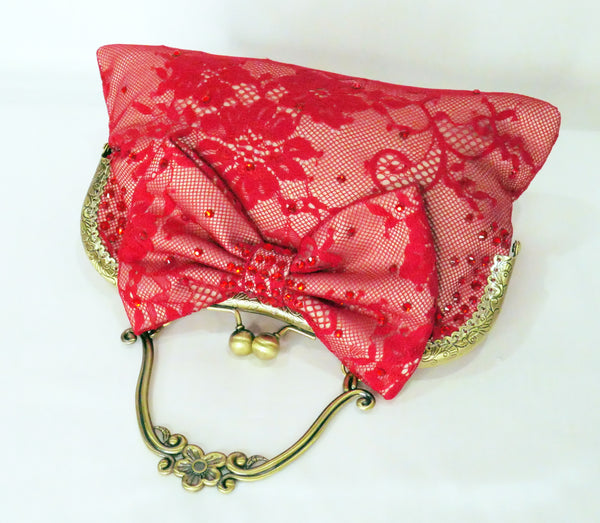 Red lace handbag with bow and antique brass handle, handmade by Rockstars and Royalty