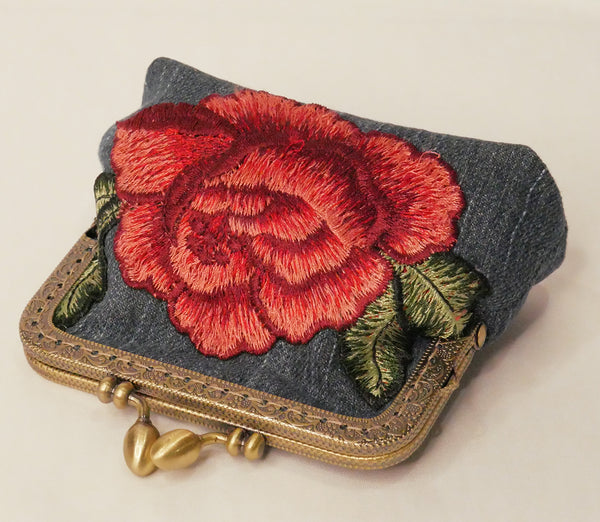 Small denim purse with red rose embroidered applique and antique brass frame