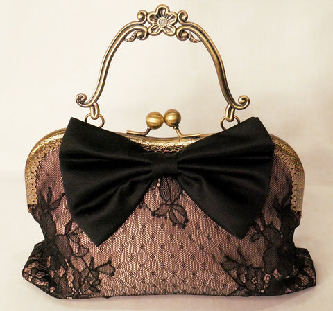 Black lace over blush satin handbag with black bow and antique brass frame with handle