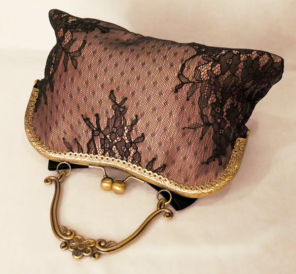 Black lace over blush satin handbag with black bow and antique brass frame with handle