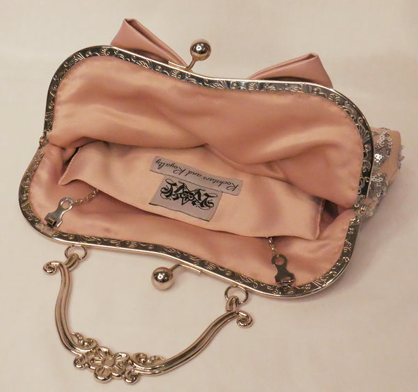 Blush pink satin and silver sequin lace handbag with a bow, silver frame and handle
